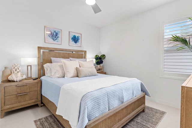 bedroom with light tile patterned floors, ceiling fan, and baseboards