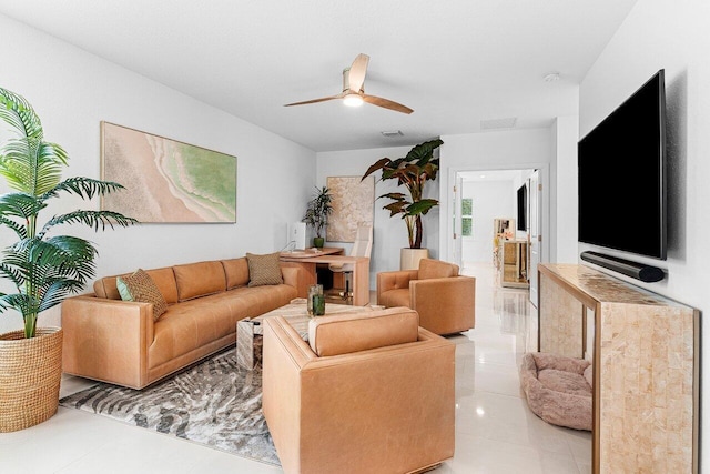 tiled living room featuring visible vents and a ceiling fan