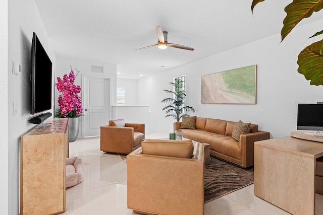 living area with visible vents, ceiling fan, and light tile patterned flooring