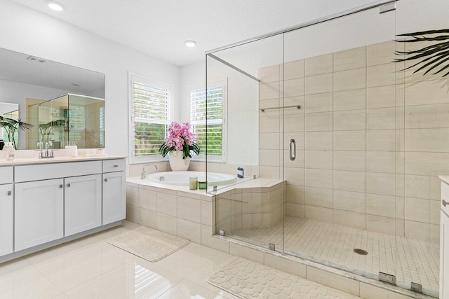 full bathroom featuring tile patterned flooring, a garden tub, a shower stall, and vanity