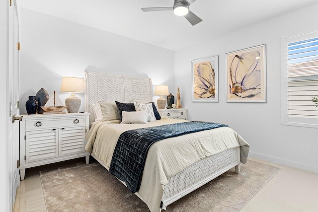 bedroom with tile patterned flooring, baseboards, and a ceiling fan