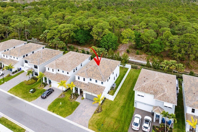 birds eye view of property with a residential view and a wooded view