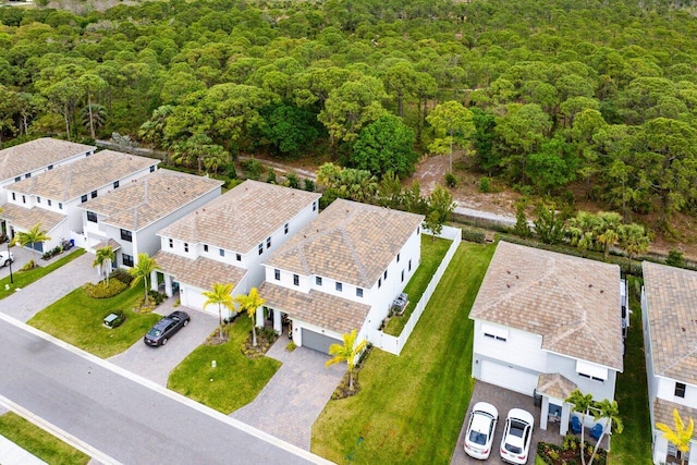 birds eye view of property with a forest view and a residential view