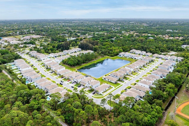 drone / aerial view featuring a water view and a residential view