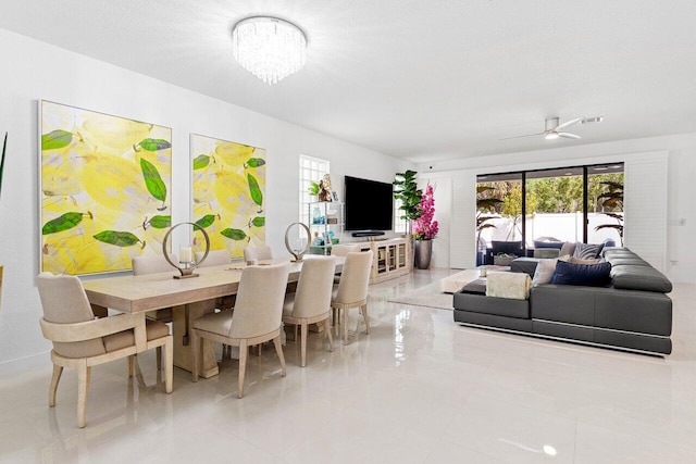 dining room with a textured ceiling and ceiling fan with notable chandelier