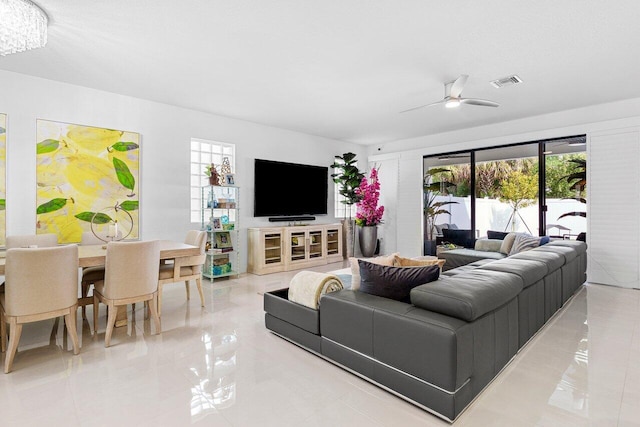 living room featuring visible vents and ceiling fan