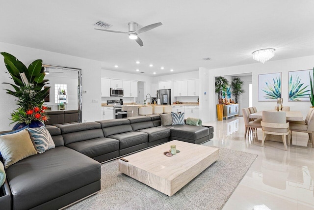 living area featuring recessed lighting, visible vents, and a ceiling fan