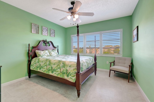 bedroom with ceiling fan, a textured ceiling, and baseboards