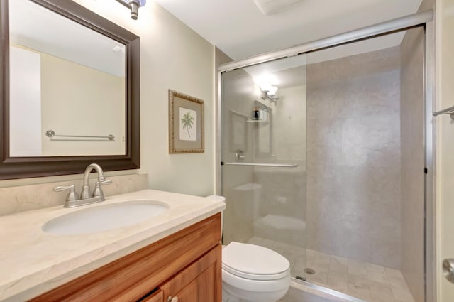 full bathroom featuring vanity, toilet, and a shower stall