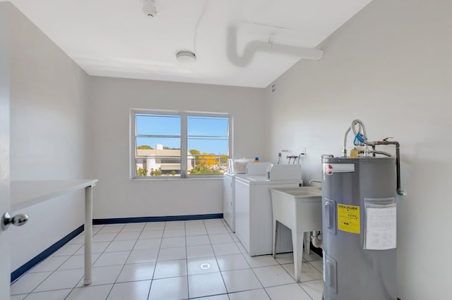 laundry room with independent washer and dryer, water heater, light tile patterned floors, baseboards, and laundry area