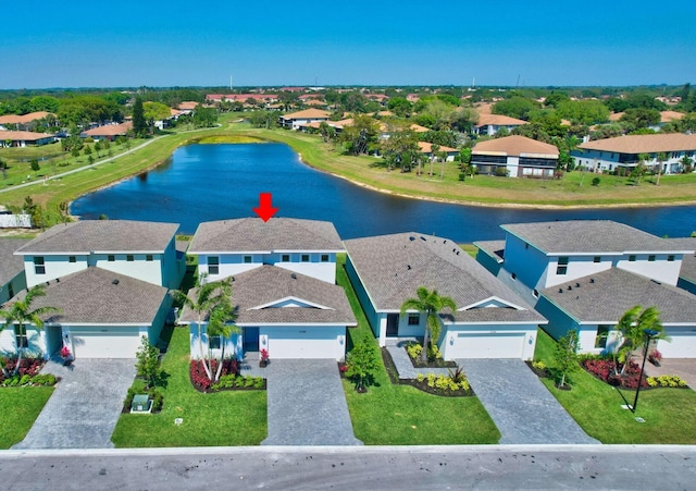 drone / aerial view with a water view and a residential view