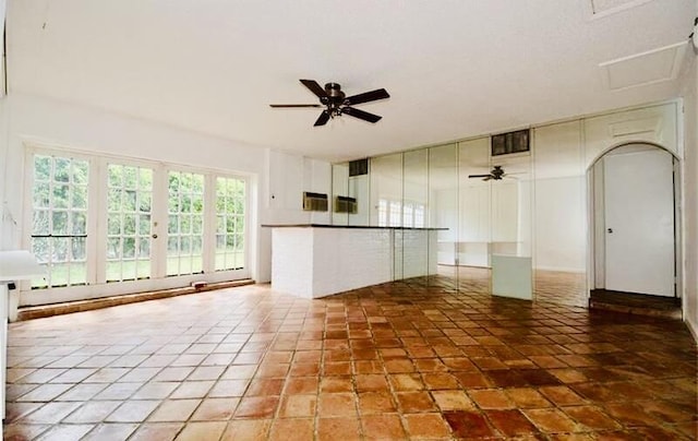 empty room with ceiling fan, visible vents, a baseboard radiator, and light tile patterned flooring