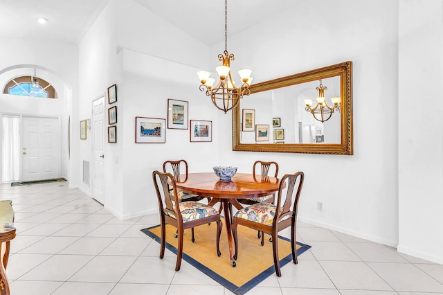 dining area with light tile patterned floors, baseboards, and an inviting chandelier