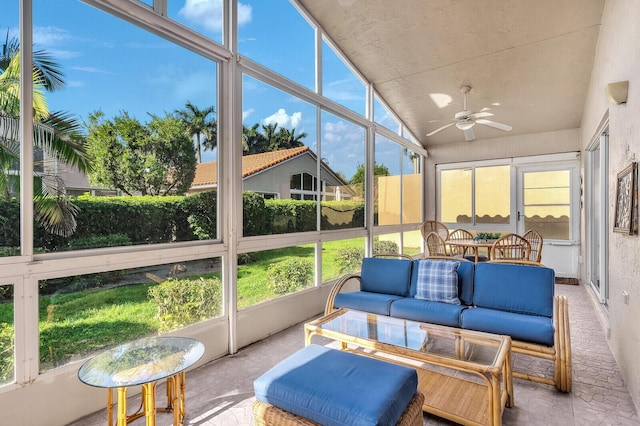 sunroom with vaulted ceiling and a ceiling fan