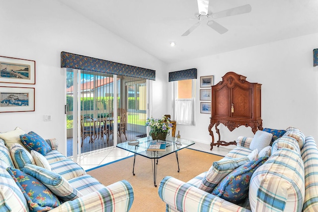 living area with a ceiling fan, lofted ceiling, and light tile patterned flooring