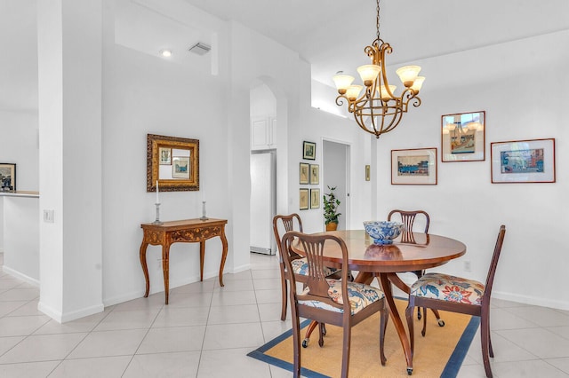 dining room featuring baseboards, visible vents, arched walkways, and light tile patterned flooring