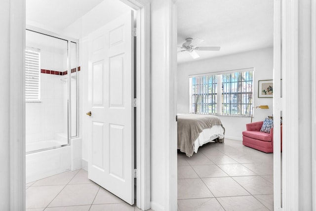 bedroom with light tile patterned floors, a ceiling fan, and baseboards