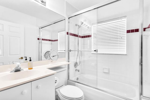 full bathroom with toilet, shower / bath combination with glass door, and vanity