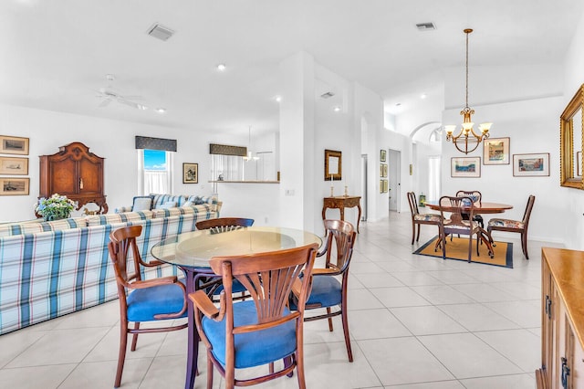 dining space with light tile patterned floors, vaulted ceiling, and visible vents