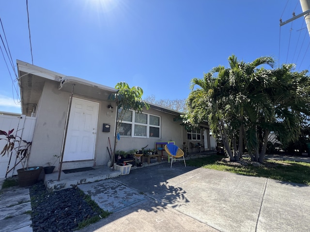 exterior space with a patio and stucco siding