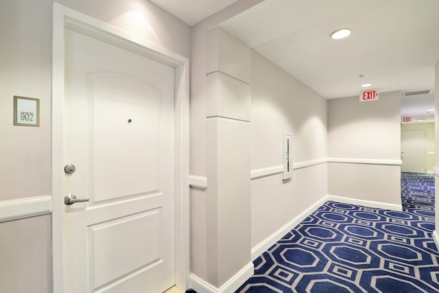 hallway with recessed lighting and baseboards