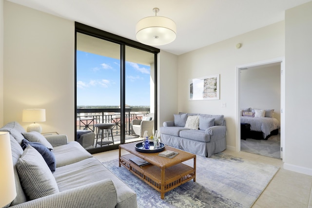 living area featuring a wall of windows, baseboards, and tile patterned floors