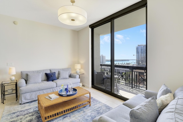 tiled living area featuring a view of city, a wall of windows, and baseboards