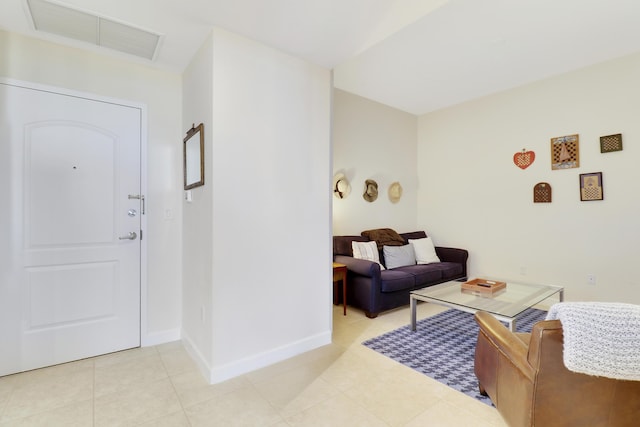 living area featuring light tile patterned floors, baseboards, and visible vents