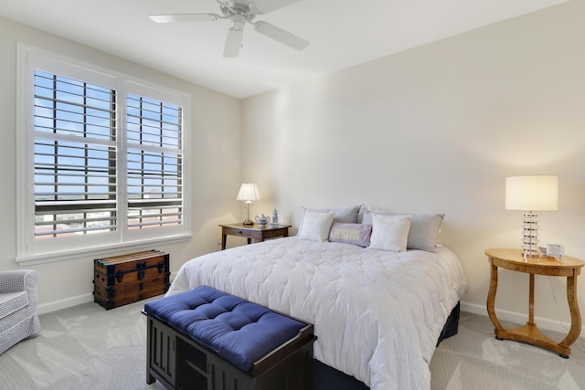 carpeted bedroom featuring baseboards and a ceiling fan