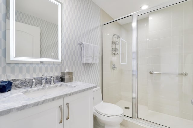 full bathroom with a shower stall, wallpapered walls, vanity, and toilet