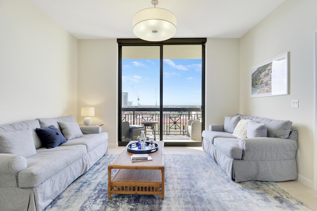 living room with expansive windows and baseboards