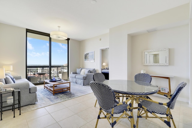 dining area with baseboards, light tile patterned flooring, and floor to ceiling windows