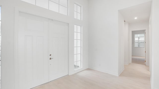 entrance foyer featuring light wood-style floors and baseboards