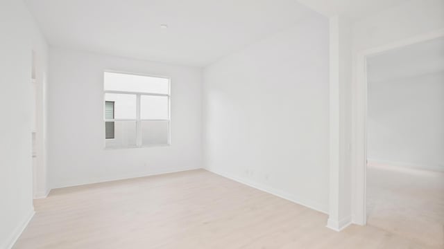 spare room with light wood-type flooring