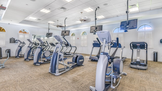 workout area featuring baseboards, visible vents, and carpet flooring