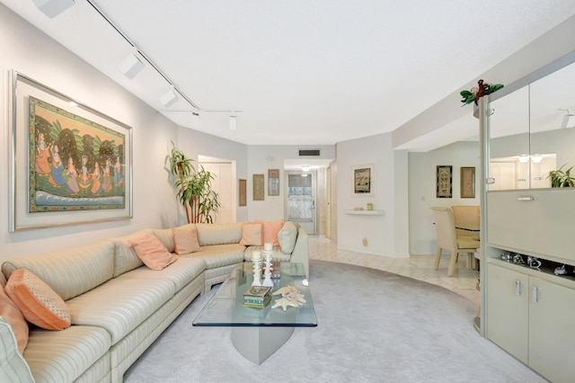 living area with carpet floors, visible vents, and track lighting