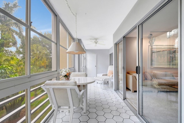 sunroom / solarium featuring a ceiling fan and a healthy amount of sunlight