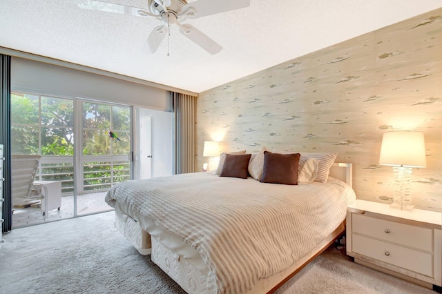 bedroom with a textured ceiling, ceiling fan, light colored carpet, access to exterior, and wallpapered walls