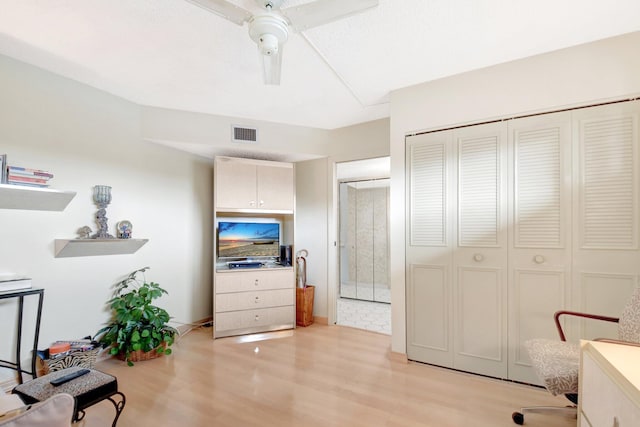 bedroom featuring ceiling fan, a closet, visible vents, and light wood-style floors