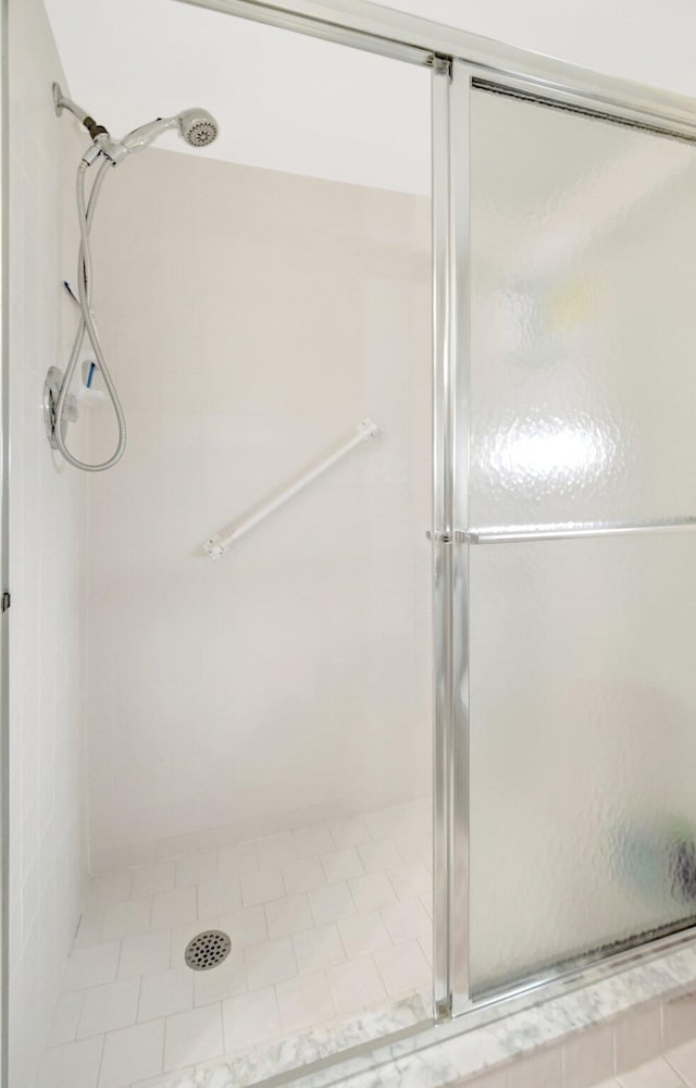 full bath with a shower stall