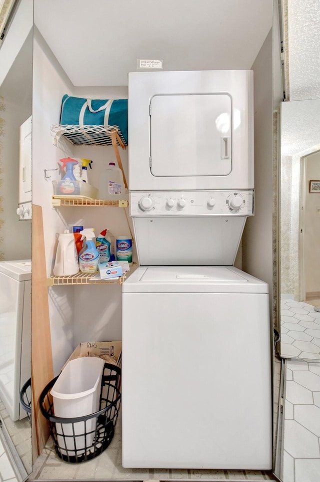 washroom featuring laundry area and stacked washer / dryer