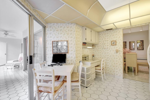 dining area featuring light tile patterned floors, ceiling fan, and wallpapered walls