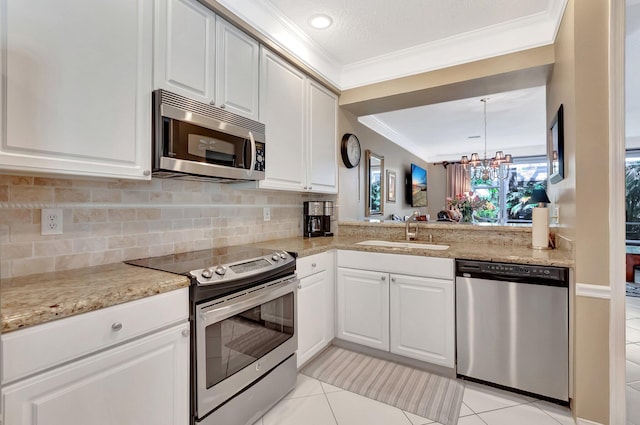 kitchen featuring backsplash, appliances with stainless steel finishes, ornamental molding, light tile patterned flooring, and a sink