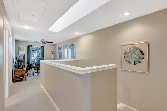 corridor featuring visible vents, attic access, light carpet, an upstairs landing, and baseboards