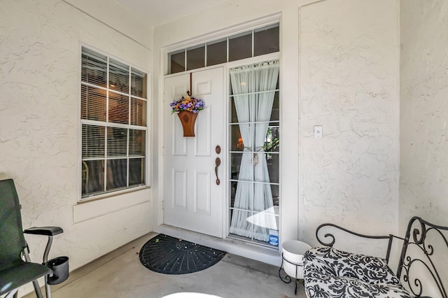 property entrance featuring stucco siding