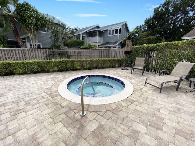 view of swimming pool with a patio area, fence, and a community hot tub