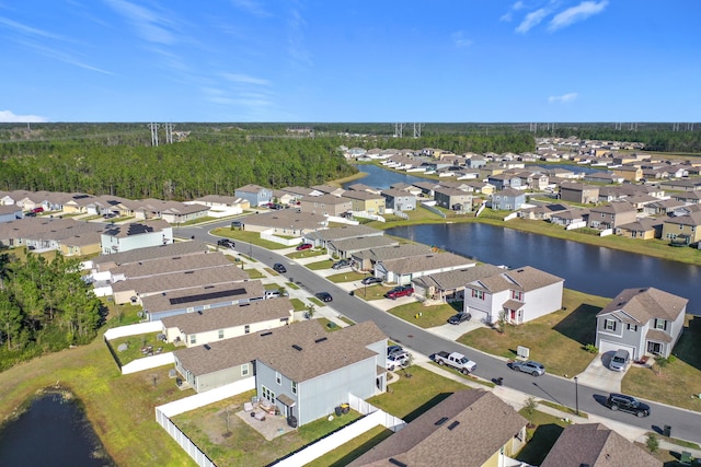 drone / aerial view with a residential view and a water view