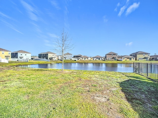 water view featuring a residential view and fence