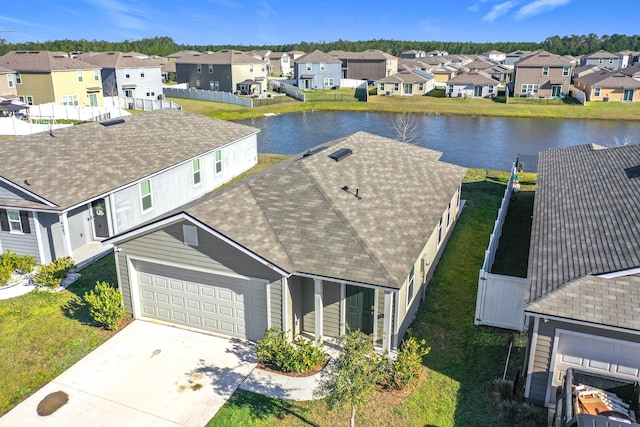 birds eye view of property with a residential view and a water view