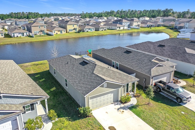 birds eye view of property with a residential view and a water view